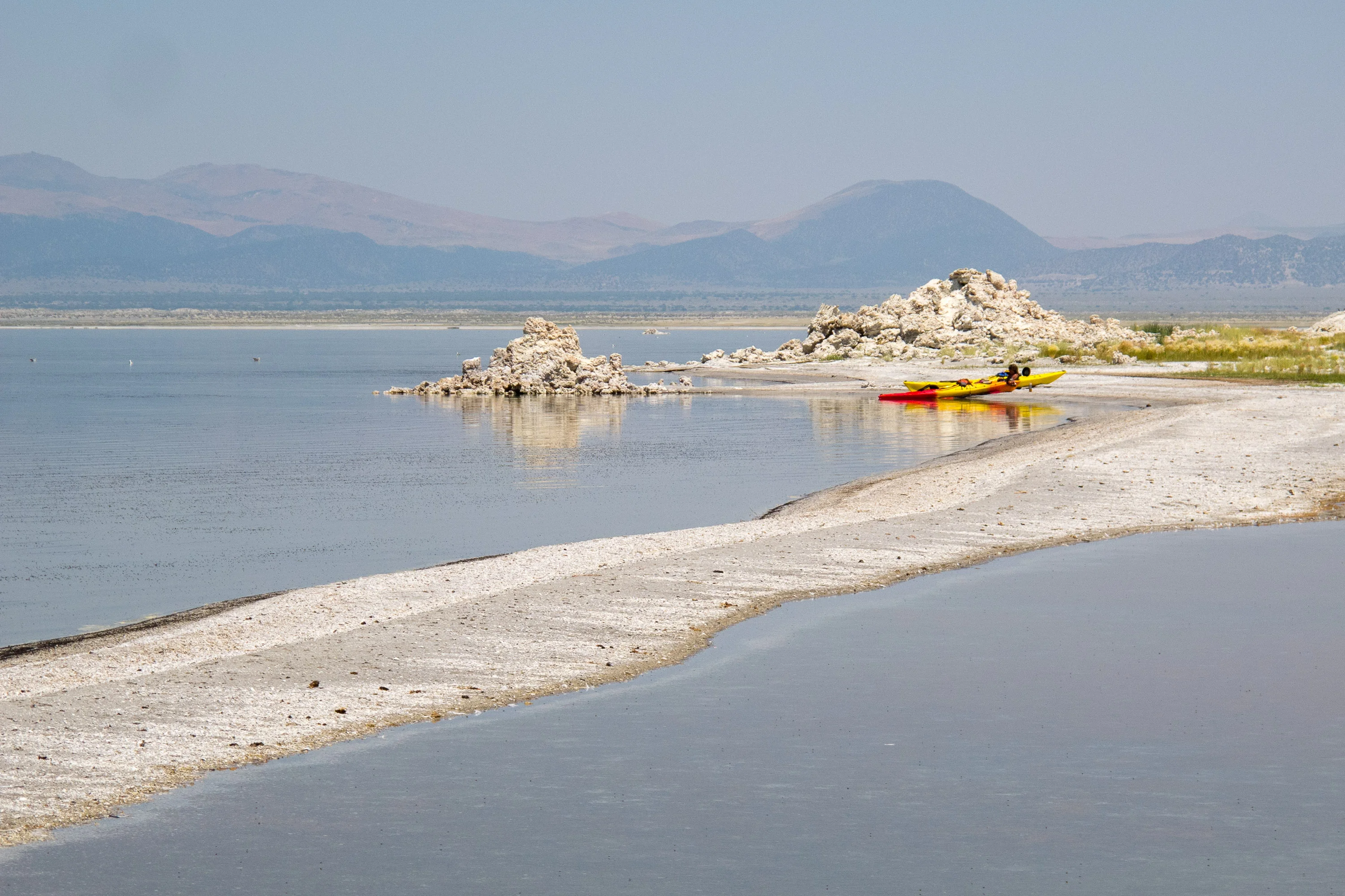 Sand spit by remote tufas