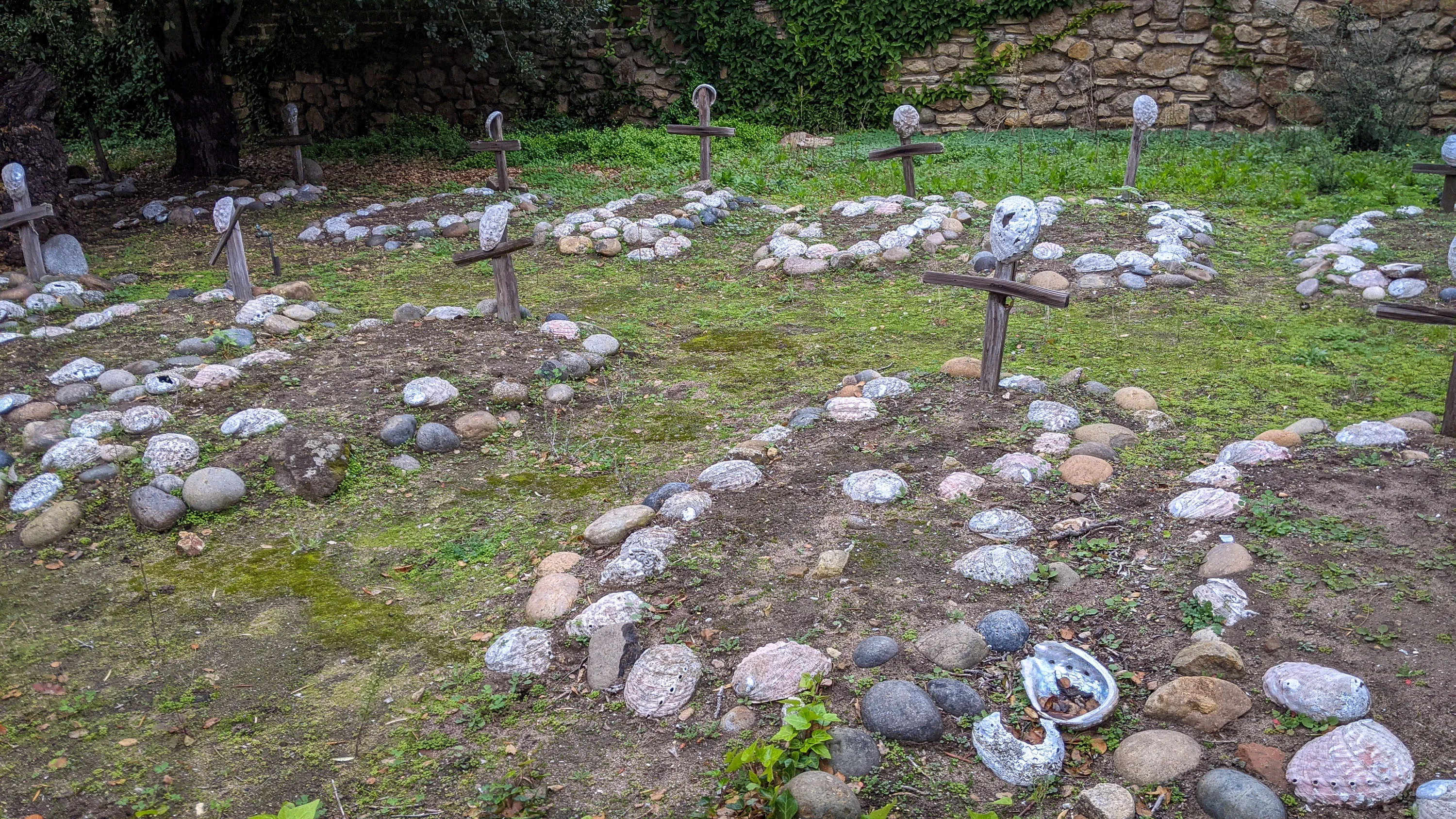 Unnamed graves marked by abalone shells, representing the indigenous people who died here